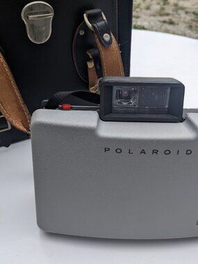 Polaroid 210 Land Camera With Case, Flashbulbs, Coldclip, And Other Accessories